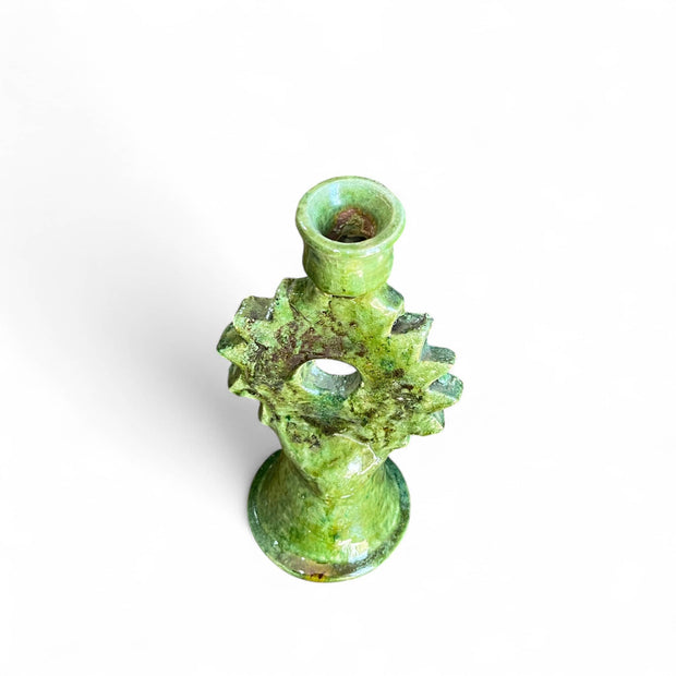 Green ceramic gear-shaped candle holder on a white background