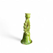 Green textured candle holder on a white background