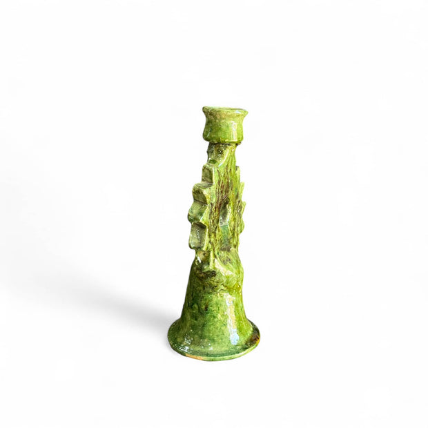 Green textured candle holder on a white background