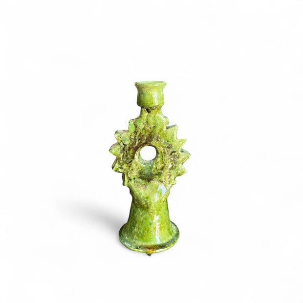 Green ceramic candle holder with textured design on a white background