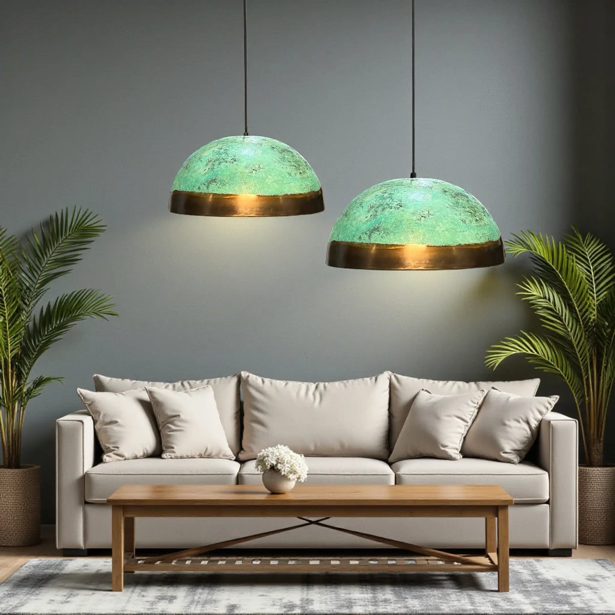 Handmade oxidized copper Moroccan pendant light with green patina and brass base hanging in modern living room