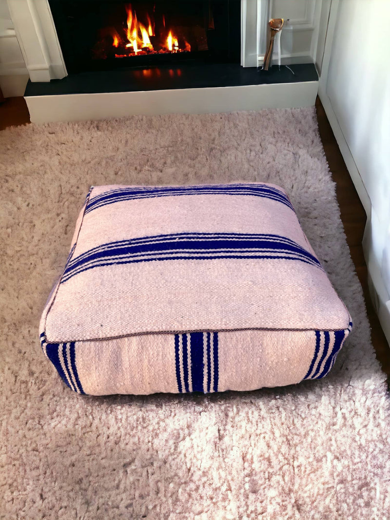 Authentic Moroccan charm in every thread. Unstuffed Berber rug pouf, crafted from 100% wool for warmth and comfort. A historic touch with a Moroccan pattern, ready for your personalization. Smooth zipper for easy customization. Embrace the authenticity delivered to your doorstep.