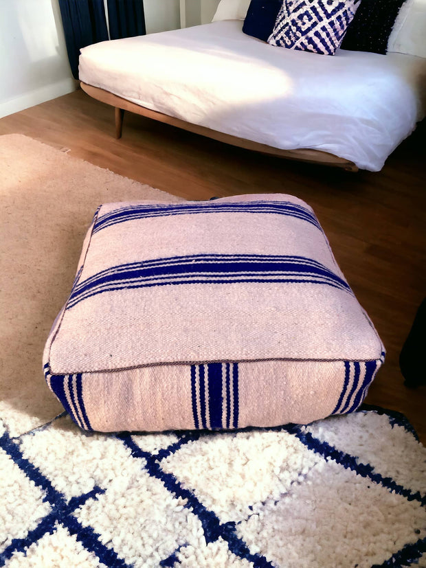 Authentic Moroccan charm in every thread. Unstuffed Berber rug pouf, crafted from 100% wool for warmth and comfort. A historic touch with a Moroccan pattern, ready for your personalization. Smooth zipper for easy customization. Embrace the authenticity delivered to your doorstep.