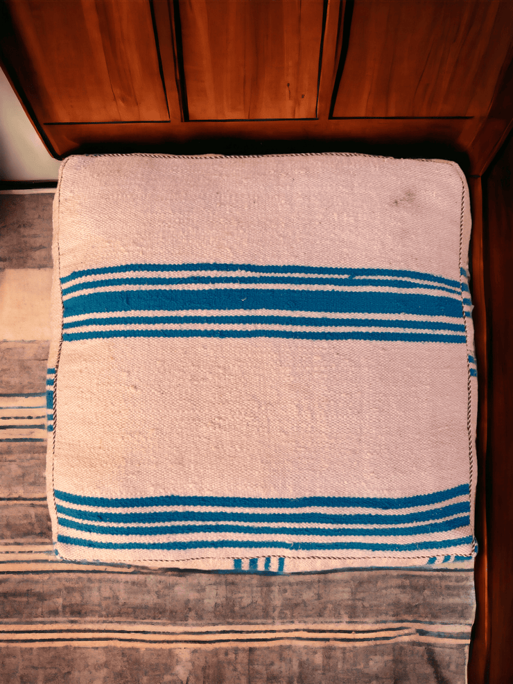 Authentic Moroccan charm in every thread. Unstuffed Berber rug pouf, crafted from 100% wool for warmth and comfort. A historic touch with a Moroccan pattern, ready for your personalization. Smooth zipper for easy customization. Embrace the authenticity delivered to your doorstep.