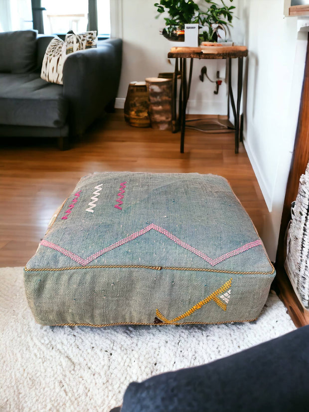 Introducing our Handmade Cactus Silk Pouf – a luxurious addition to your living space. Crafted from Sabra Silk, this square pouf brings Moroccan charm to your home. Elevate your living room with the unique design of a silk Ottoman Footstool. Immerse yourself in the comfort and style of this carefully Handmade Ottoman Pouf.