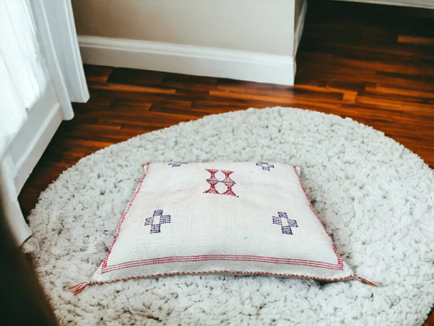 Handmade lumbar cushion with intricate Moroccan Sabra design, perfect for home decor.