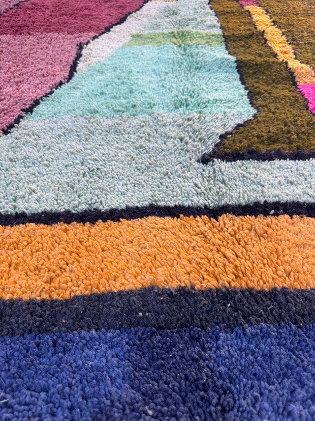 Close-up of a textured rug with multicolored stripes