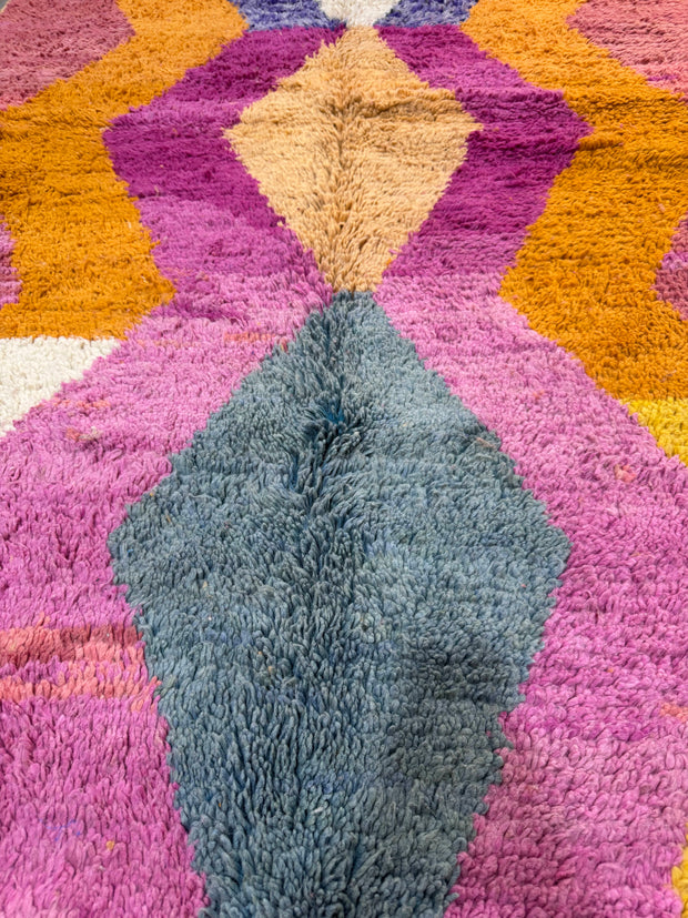 Multicolored textured rug with geometric pattern