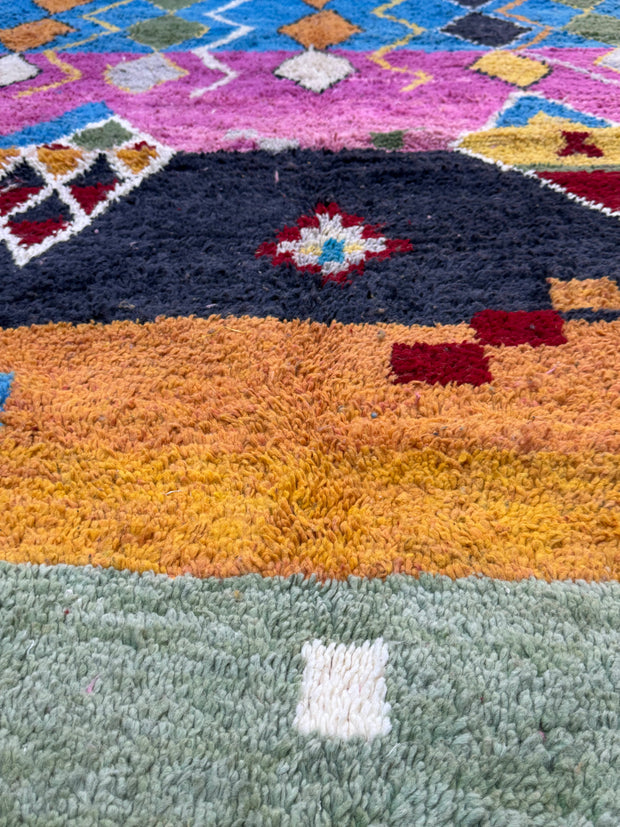 Close-up of textured rugs in various colors and patterns