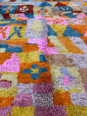 Multicolored textured rug with a patchwork pattern