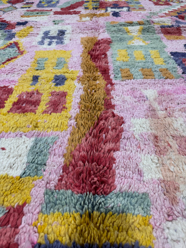 Handwoven Moroccan Bjaad carpet with vibrant pink medina-inspired geometric motifs in multicolor wool, 266 × 159 cm