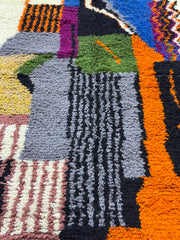 Handwoven Moroccan Azilal carpet with abstract earth and sky color-block pattern in natural wool, 255 × 137 cm