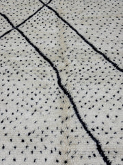 Textured fabric with black thread pattern on a light background