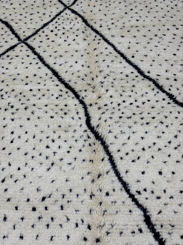 Textured fabric with black thread pattern on a light background