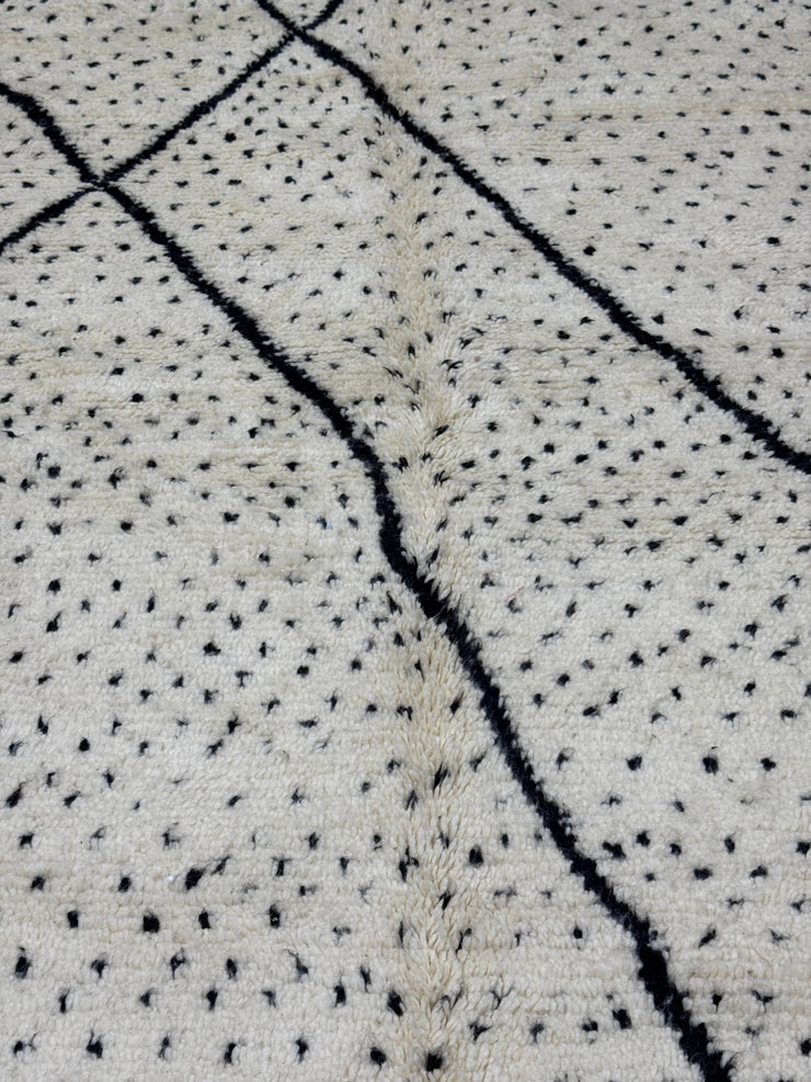 Textured fabric with black thread pattern on a light background
