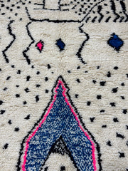Close-up of a textured fabric with geometric patterns and colors.
