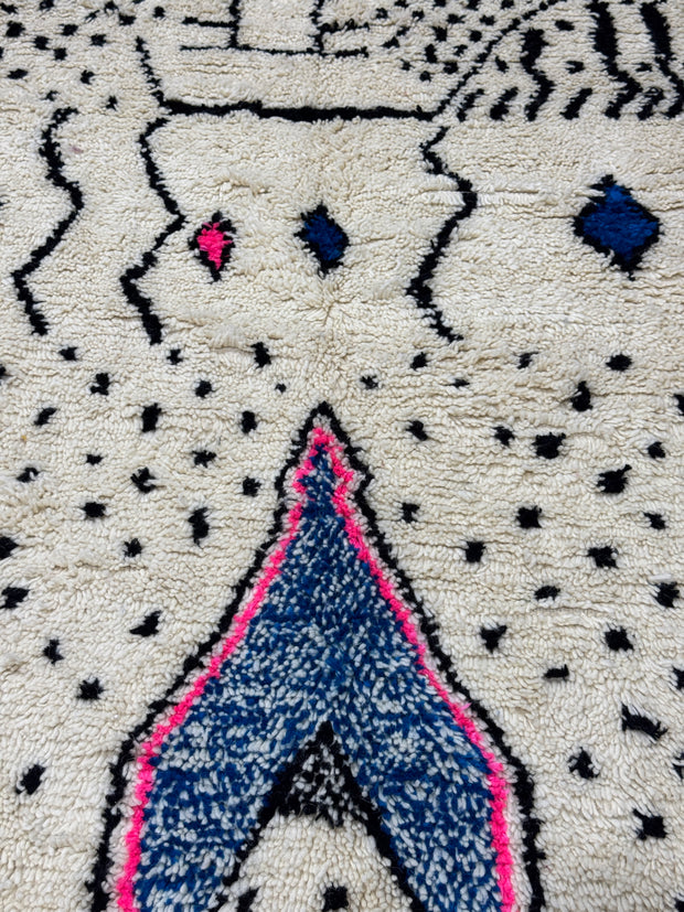Close-up of a textured fabric with geometric patterns and colors.