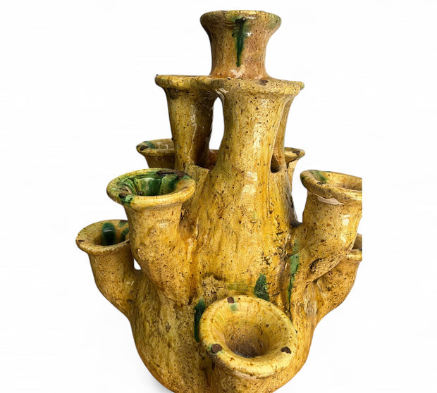 Yellow ceramic vase with multiple small pots on a white background