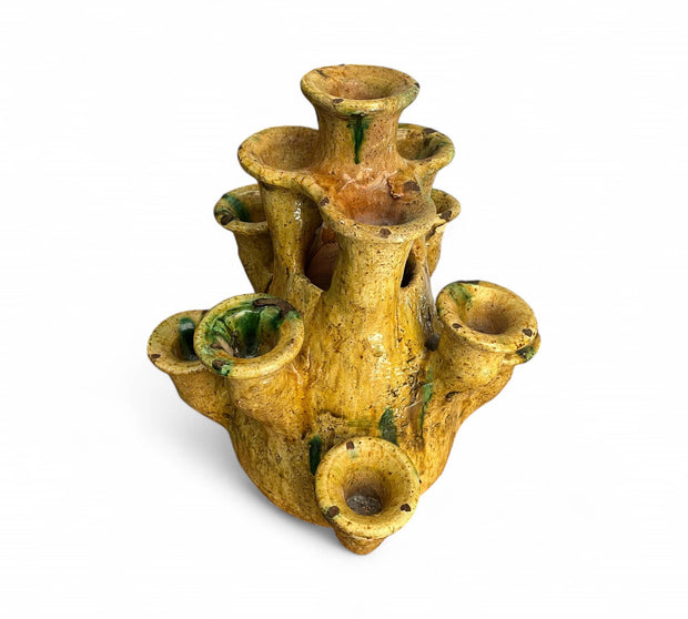 Yellow ceramic candle holder with multiple nozzles on a white background