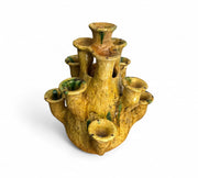 Yellow ceramic vase with multiple nozzles on a white background