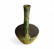Green ceramic oil lamp on a white background