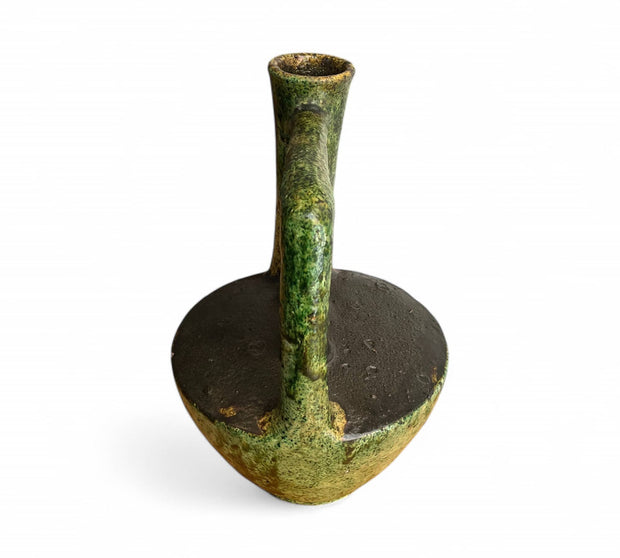Green ceramic oil lamp on a white background