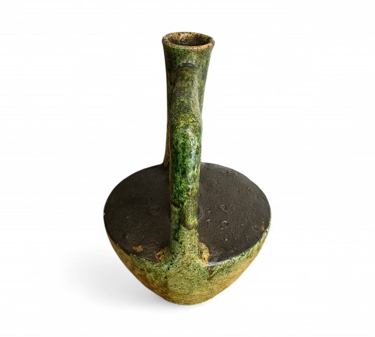 Green ceramic oil lamp on a white background