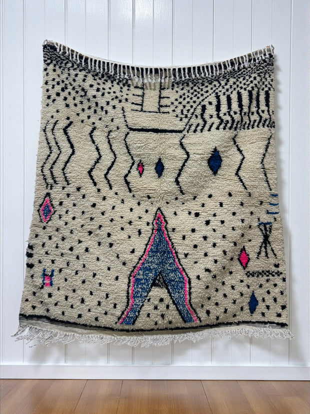 Handwoven Moroccan Azilal carpet in ivory wool with black, indigo, and pink Berber motifs, 223 × 156 cm