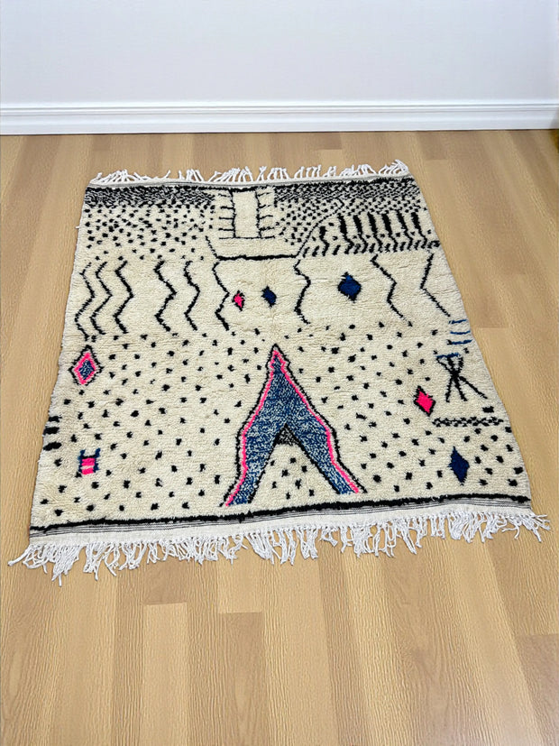 Handwoven Moroccan Azilal carpet in ivory wool with black, indigo, and pink Berber motifs, 223 × 156 cm