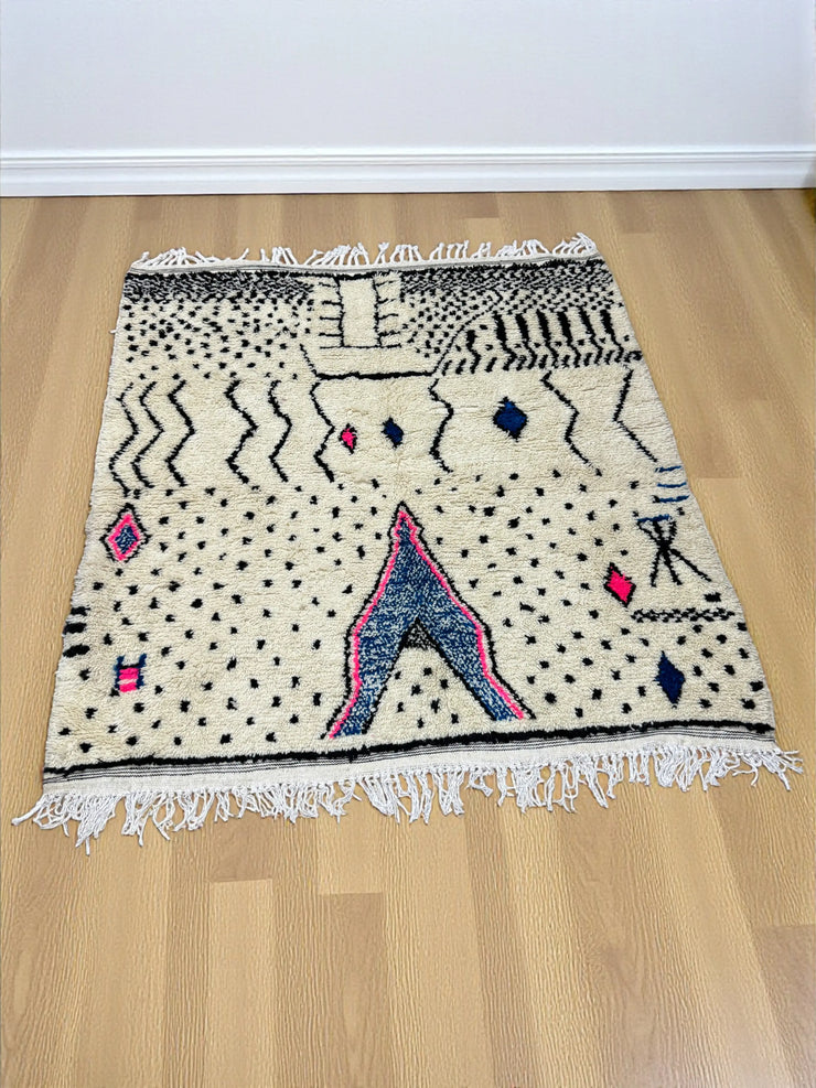 Handwoven Moroccan Azilal carpet in ivory wool with black, indigo, and pink Berber motifs, 223 × 156 cm