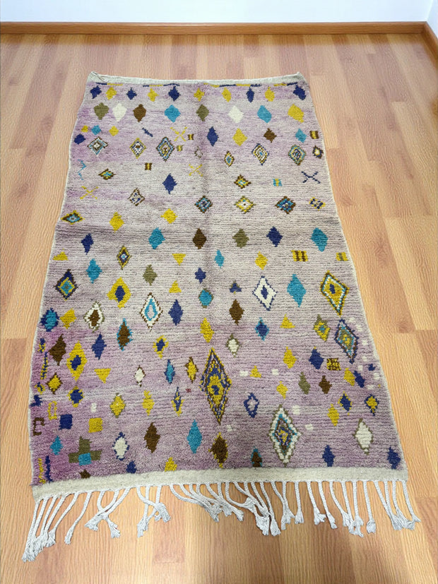 Handwoven Moroccan Bjaad carpet in lavender with diamond motifs and colorful accents, 249 × 154 cm