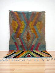 Handwoven Moroccan Bjaad carpet with bold geometric tribal design in multicolor wool, 247 × 164 cm