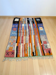 Handwoven Moroccan Bjaad carpet with abstract tribal striped design in multicolor wool, 242 × 166 cm
