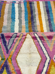 Close-up of a colorful woven textile with geometric patterns.