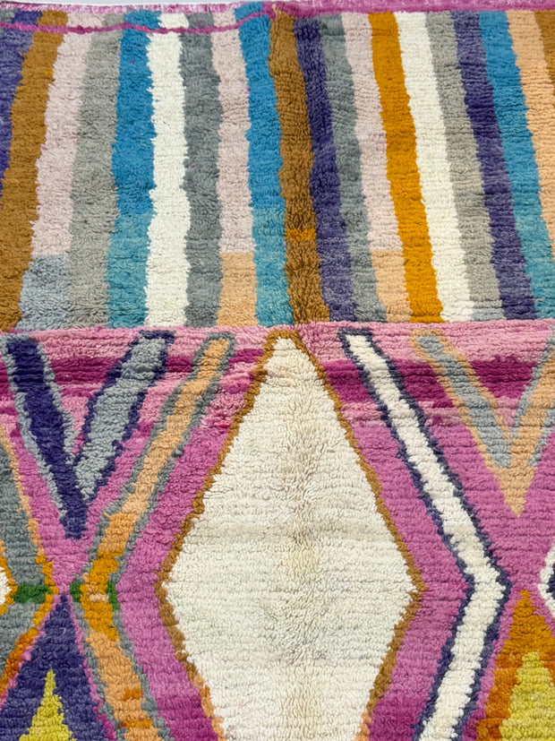 Close-up of a colorful woven textile with geometric patterns.
