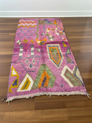 Handwoven Moroccan Bjaad carpet with blush pink geometric tribal motifs in multicolor wool, 269 × 147 cm