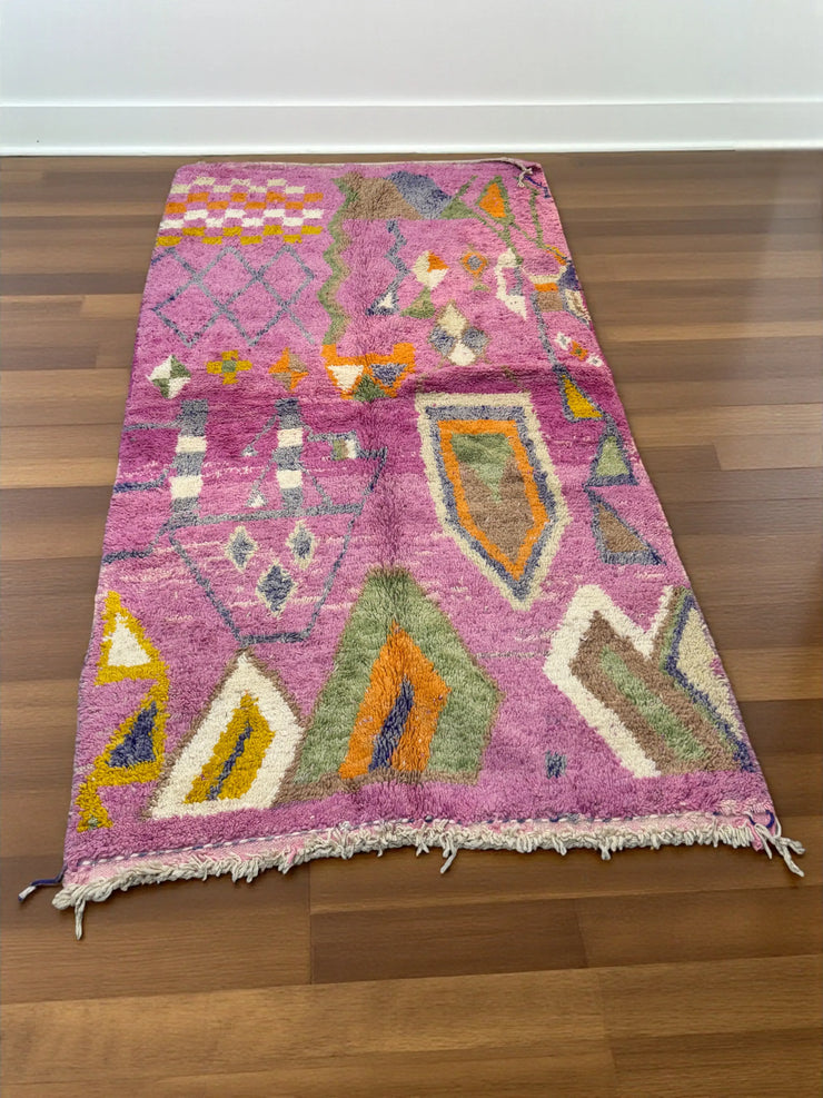 Handwoven Moroccan Bjaad carpet with blush pink geometric tribal motifs in multicolor wool, 269 × 147 cm
