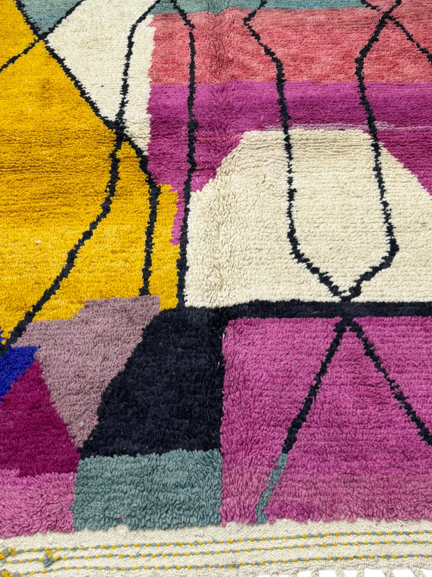 Colorful geometric-patterned rug with vibrant colors on a white background
