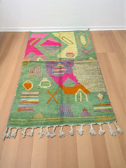 Handwoven Moroccan Bjaad carpet with abstract garden-inspired geometric motifs in multicolor wool, 250 × 150 cm