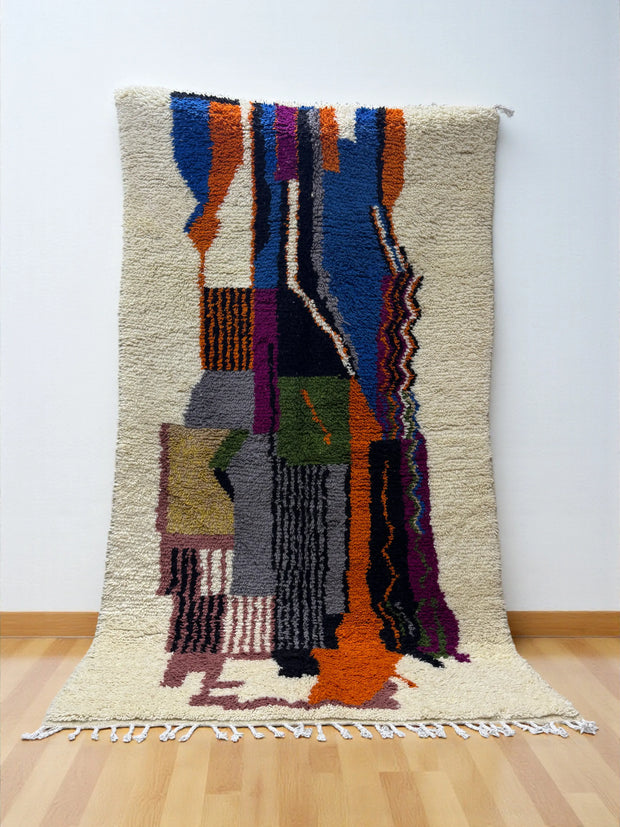 Handwoven Moroccan Azilal carpet with abstract earth and sky color-block pattern in natural wool, 255 × 137 cm