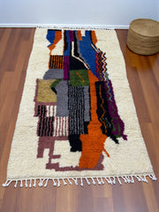 Handwoven Moroccan Azilal carpet with abstract earth and sky color-block pattern in natural wool, 255 × 137 cm