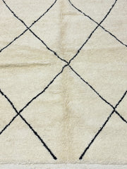 Close-up of a textured rug with a diamond pattern