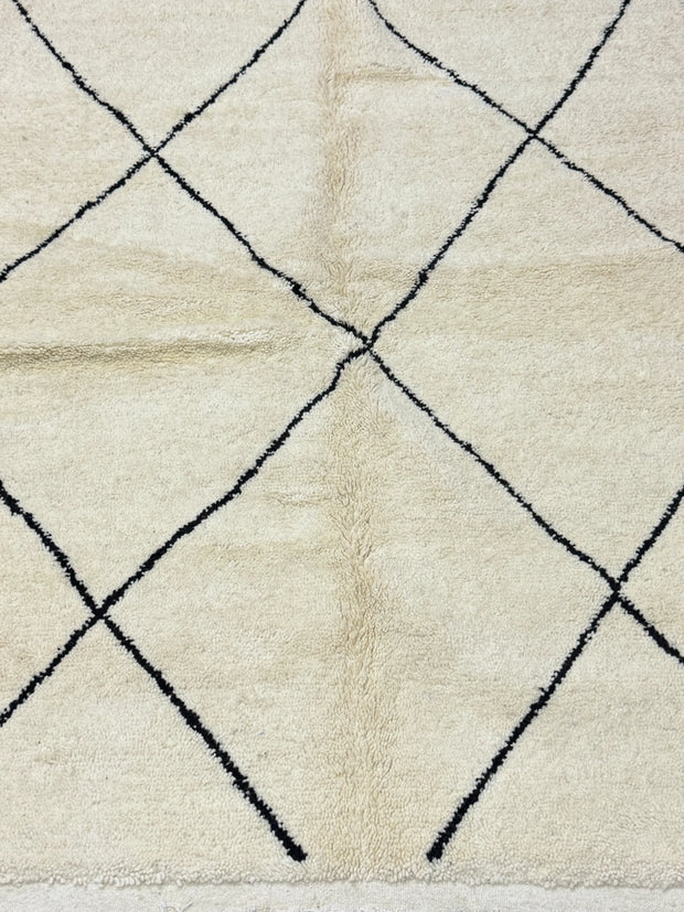 Close-up of a textured rug with a diamond pattern