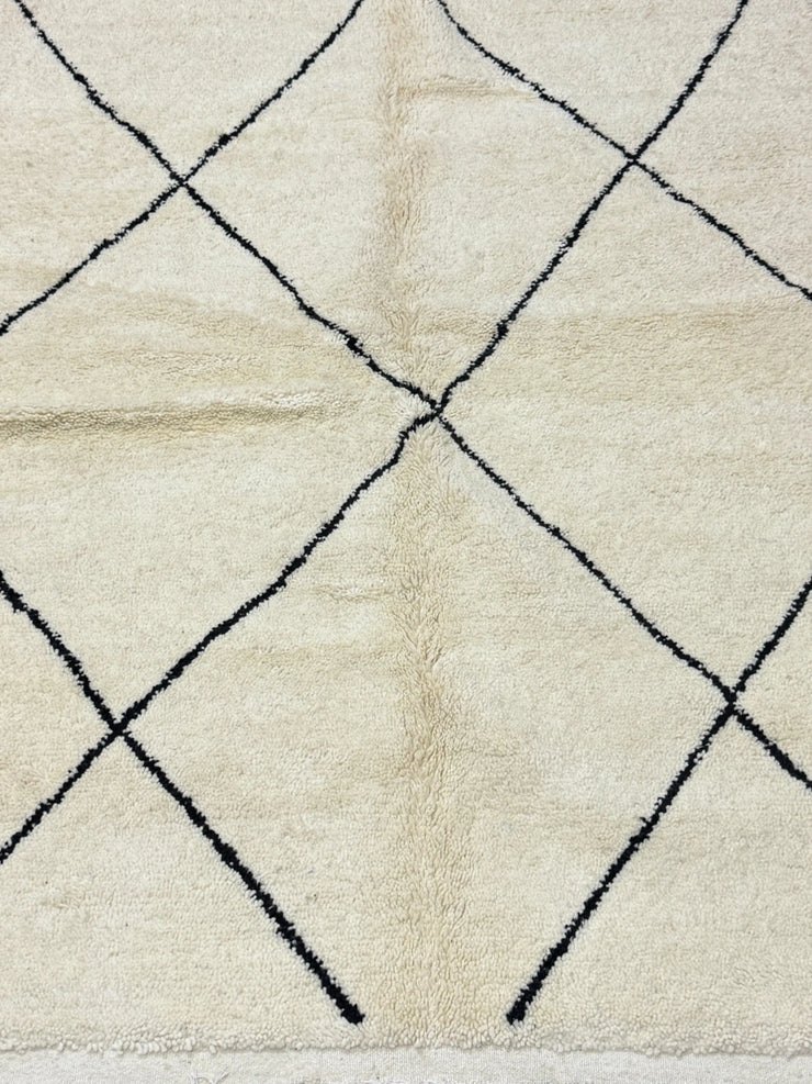 Close-up of a textured rug with a diamond pattern