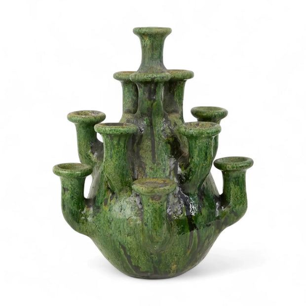Green ceramic candelabrum on a white background