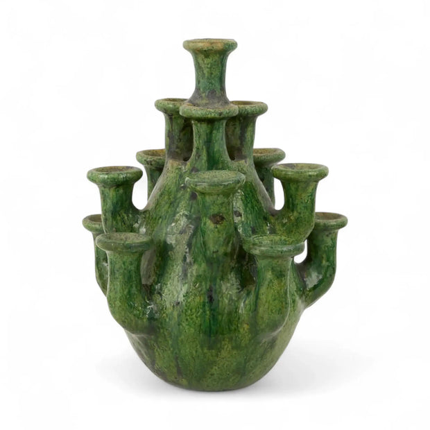 Green ceramic vase with multiple small necks on a white background