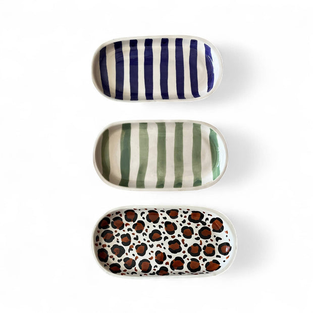 Three ceramic trays with different patterns on a white background