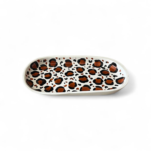 Oval ceramic plate with leopard print pattern on a white background