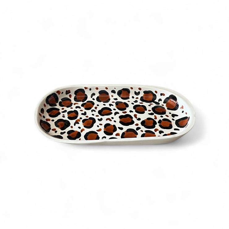 Oval ceramic plate with leopard print pattern on a white background