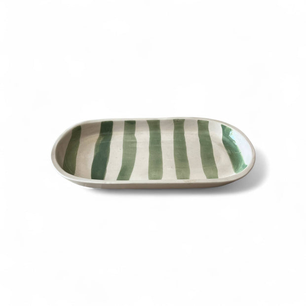 Rectangular ceramic plate with green and white stripes on a white background